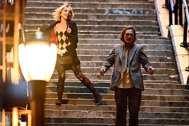 Lady Gaga and Joaquin Phoenix on stairs in Joker: Folie à Deux